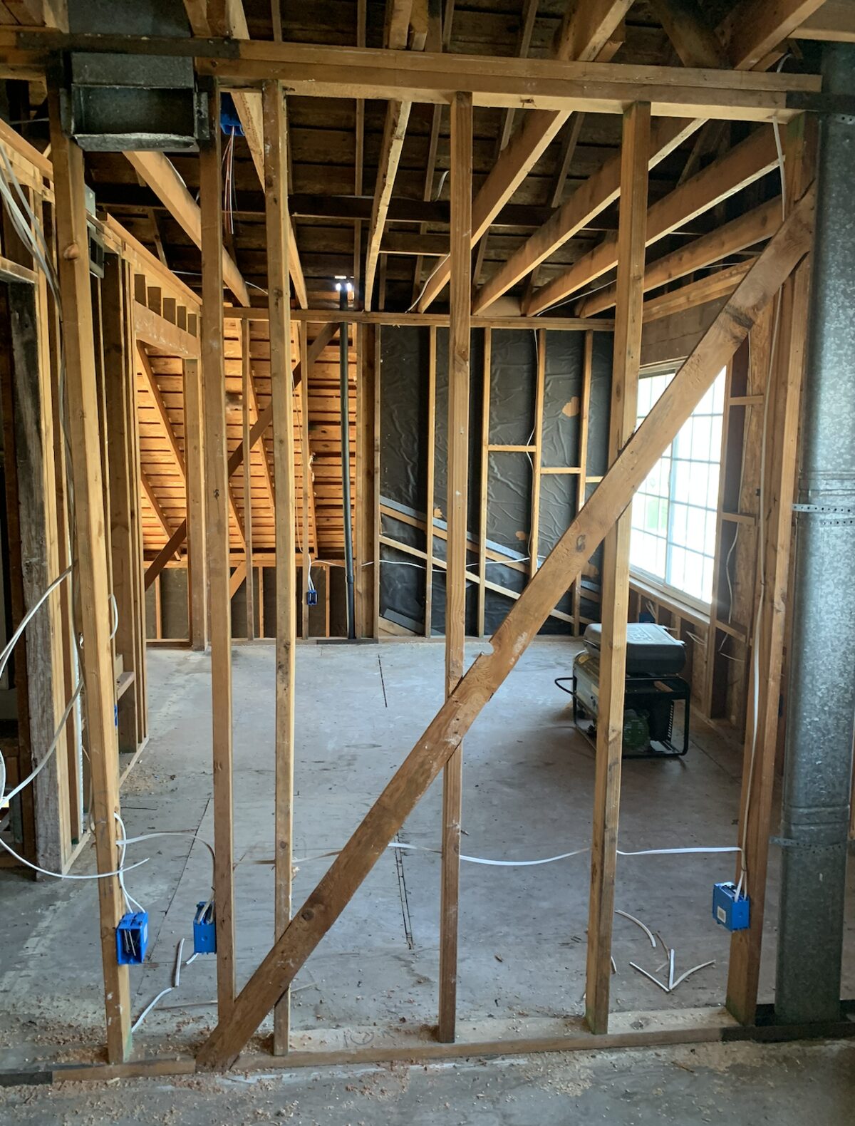 Framed room mid-remodel with new electrical boxes and wiring roughed in